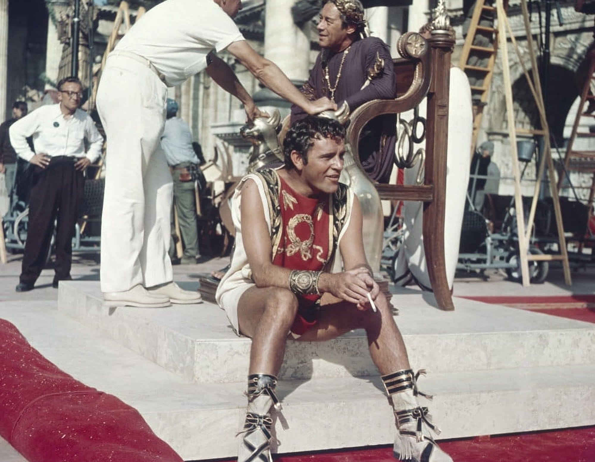 A shot of Richard Burton showing off his luscious thighs as he sits and has a smoke break on the set of Cleopatra, in costume as Mark Antony