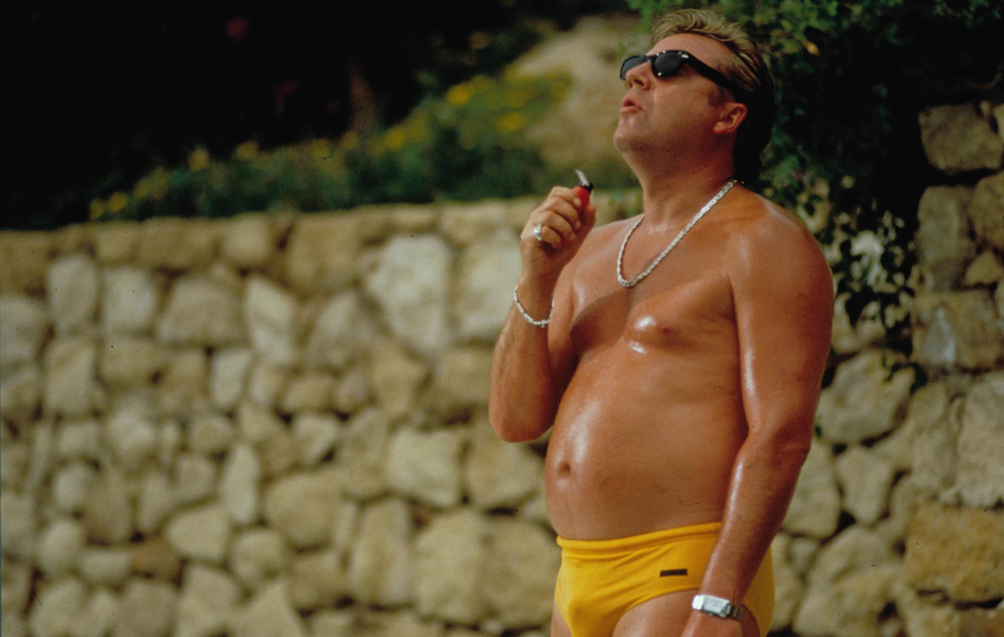 Ray Winstone in a tiny orange speedo, glistening and kind of pudgy and very sweaty in a still from Sexy Beast