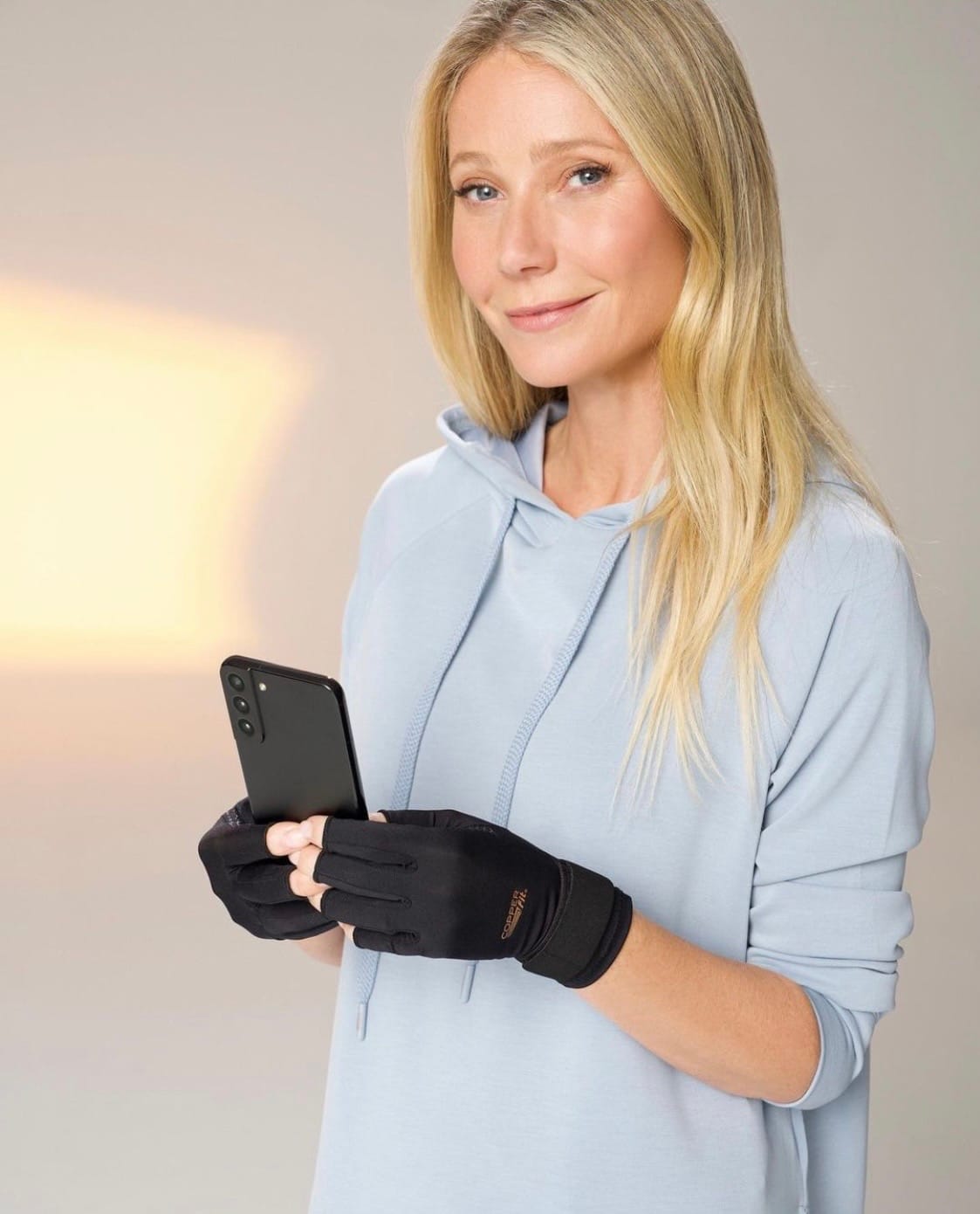 A really weird image of Gwyneth Paltrow, holding a cell phone, wearing some sort of fingerless black gloves that look possibly orthopedic? Is this an ad for carpal tunnel braces? It's inexplicable, and it's been on my phone for years