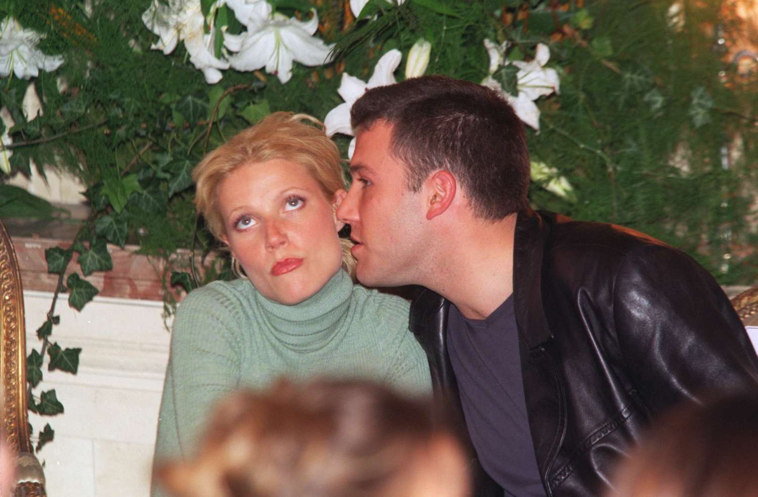 An old photo of Ben Affleck whispering into Gwyneth Paltrow's ear as she gives one of the biggest eyerolls you've ever seen - she hates his guts!