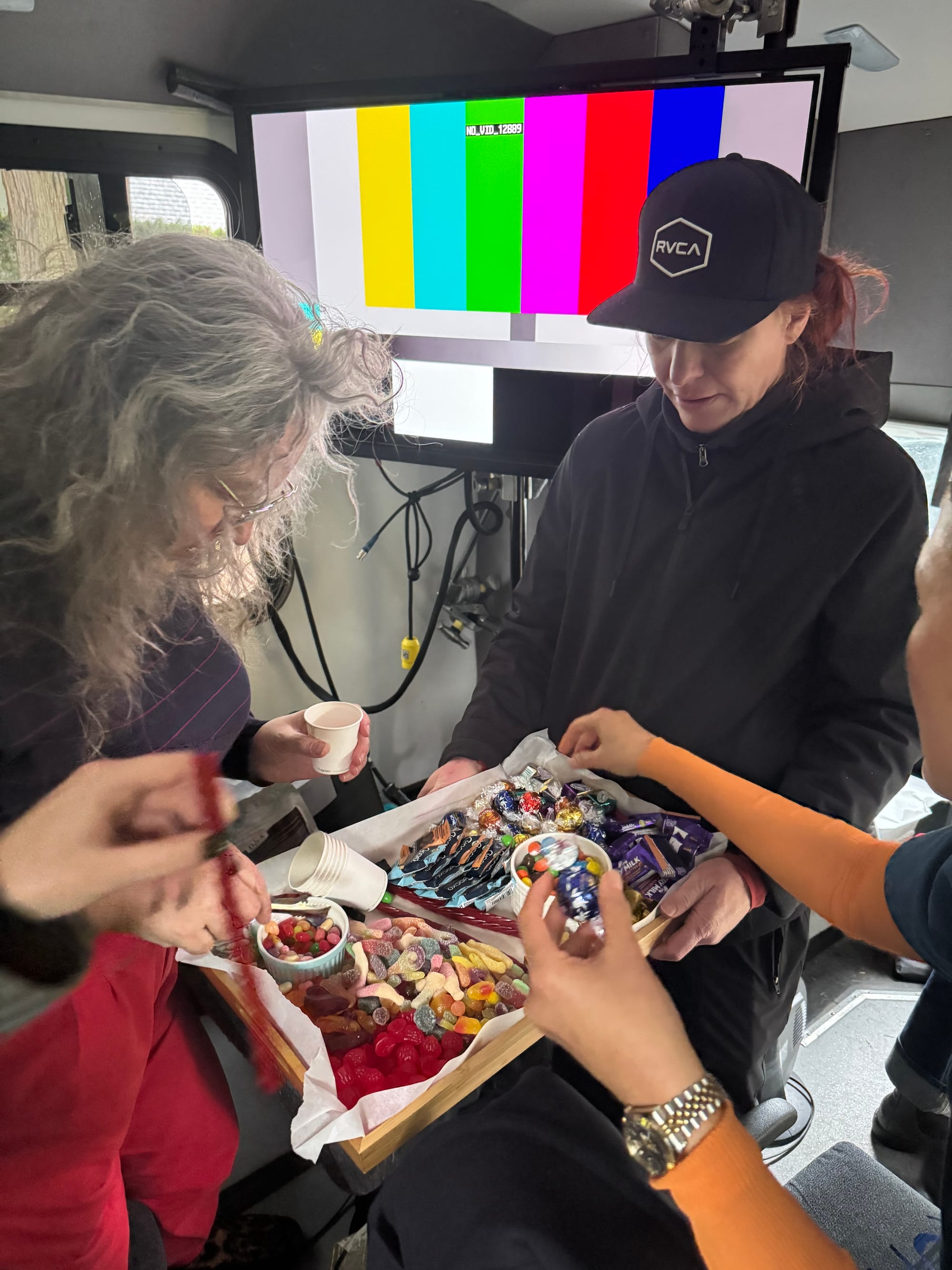 An image of our lovely craft services woman, Kristina, delivering a tray of incredible candy selection to me and my coworkers, as we all frantically grab as much candy as we can get